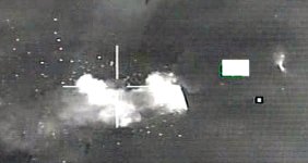 Strike imagery dated 26 March 2011 of an aircraft shelter located an an air base in Libya being struck by a Norwegian F-16 fighter plane as part of Operation Odyssey Dawn.