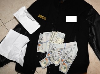 Picture of jacket bearing Menendez's name with money on top of it