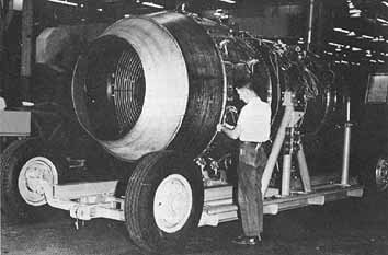 technician inspecting exposed side of model 304 jet engine
