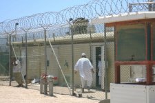 Detainees walk around the exercise yard in Camp 4, the medium security facility within Camp Delta at Naval Station Guantanamo Bay, Cuba