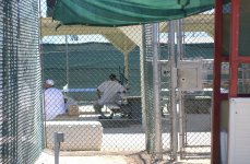 Detainees sitting in the recreation yard in Camp 4,, the medium security facility within Camp Delta at Naval Station Guantanamo Bay, Cuba