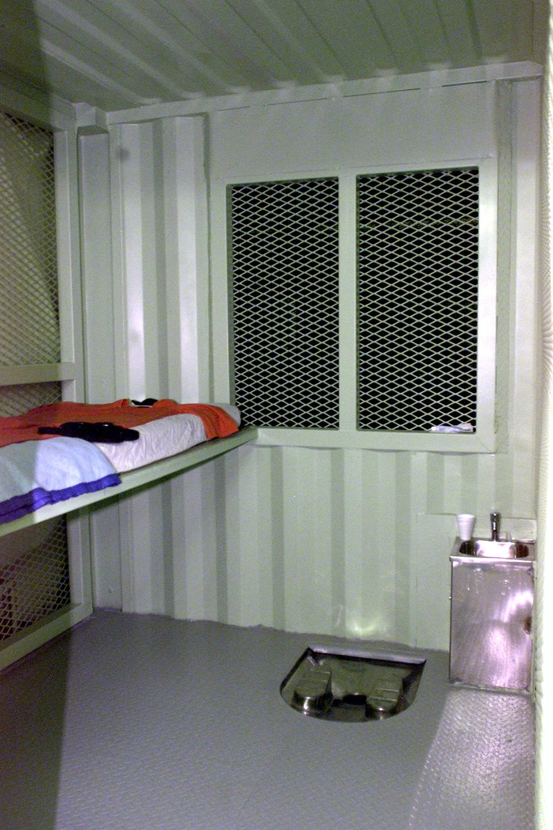 Typical Camp Delta detention facility cell, with bunk, uniform, latrine and washbasin