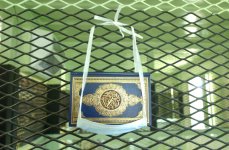 Example of copy of Koran provided to all detainees at Naval Station Guantanamo Bay, Cuba. The surgical mask is provided to the detainees so they can keep the Koran off the floor and prevent guards from touching it
