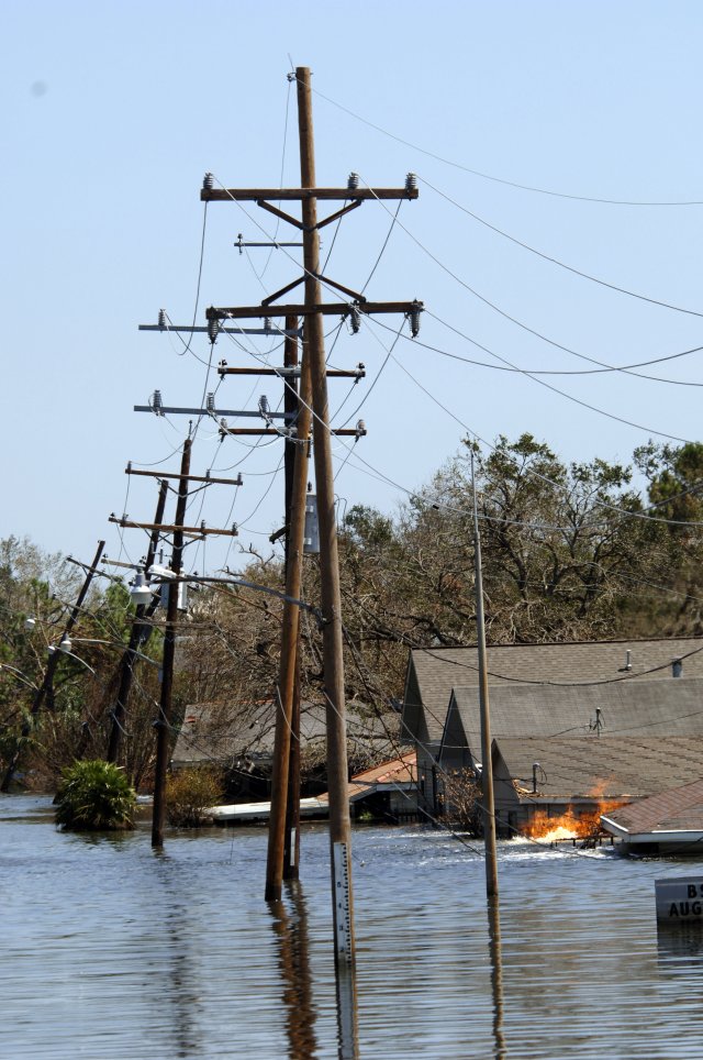 Natural gas leaking from below the flooded streets of New Orleans, La., and burning out of control near flooded homes