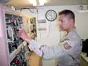 Staff Sgt. Neil Chavez, power production journeyman with the 379th Expeditionary Civil Engineer Squadron at Al Udeid Air Base, Qatar, takes an hourly reading to record changes in the power generators. (Photo by Airman 1st Class Tarkan Dospil)