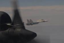 A fighter jet is seen from another aircraft.