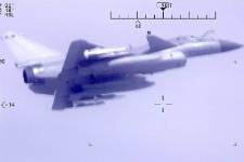 Two aircraft fly close together.