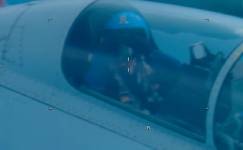 A close-up of an pilot in the cockpit of an aircraft.