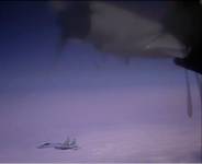 A jet flies near another, partly visible in foreground.