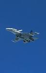 An aircraft flies against a blue sky.