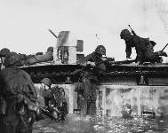 Soldiers and Marines use an LVT to transfer combat casualties to medical facilities on board Navy ships off Tinian, 26 July 1944.