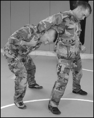 Figure 5-27. Headlock with punches, step 3.