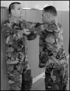 Figure 8-4. Defense against the two-hand neck press against a wall.
