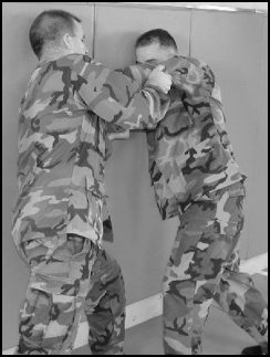 Figure 8-4. Defense against the two-hand neck press against a wall (continued).