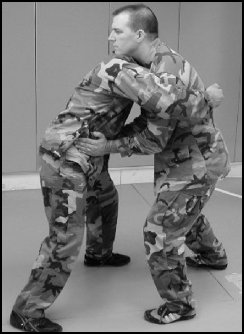 Figure 8-5. Defense against the front bear hug over your arms.