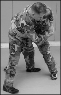Figure 8-5. Defense against the front bear hug over your arms (continued).