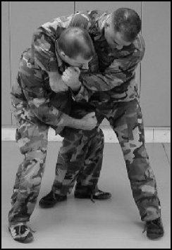 Figure 8-7. Defense against the bear hug from the rear, over the arms (continued).