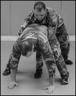 Figure 8-8. Defense against the bear hug from the rear, under the arms (continued).