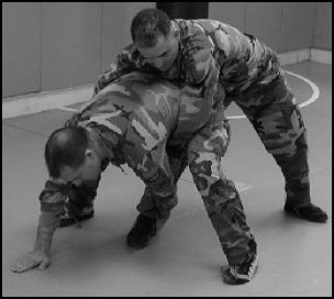 Figure 8-8. Defense against the bear hug from the rear, under the arms (continued).