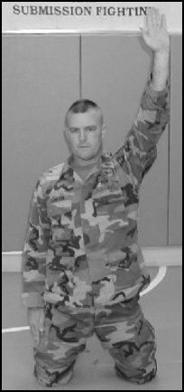 Figure 5-2. Forward rolling breakfall from the kneeling position, step 1.
