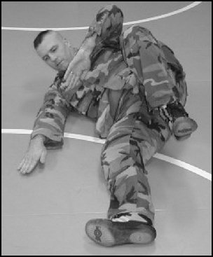 Figure 5-3. Forward rolling breakfall from the kneeling position, step 2.