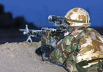 A soldier observes the front line as the sun goes down just outside Basrah