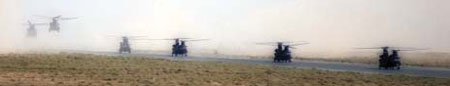 Chinook helicopters landing and taxiing at an RAF base in the Gulf
