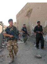 A coalition security patrol with an Iraqi policeman in Al Qurnah