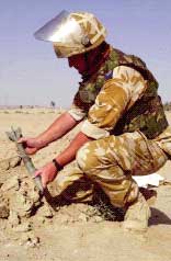 An RAF NCO prepares abandoned Iraqi munitions for disposal