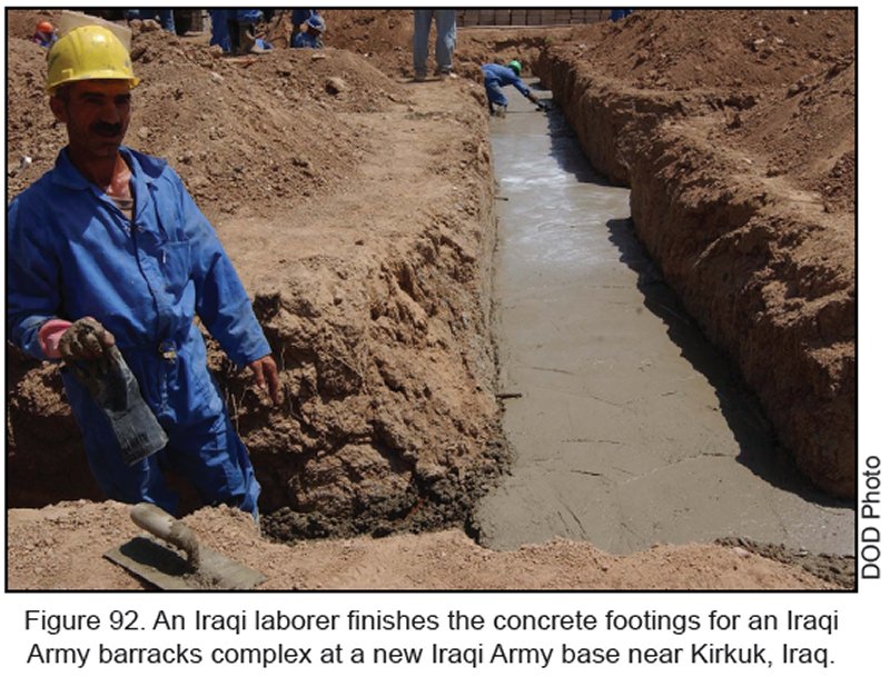 Figure 92. An Iraqi laborer finishes the concrete footings for an Iraqi Army barracks complex at a new Iraqi Army base near Kirkuk, Iraq.