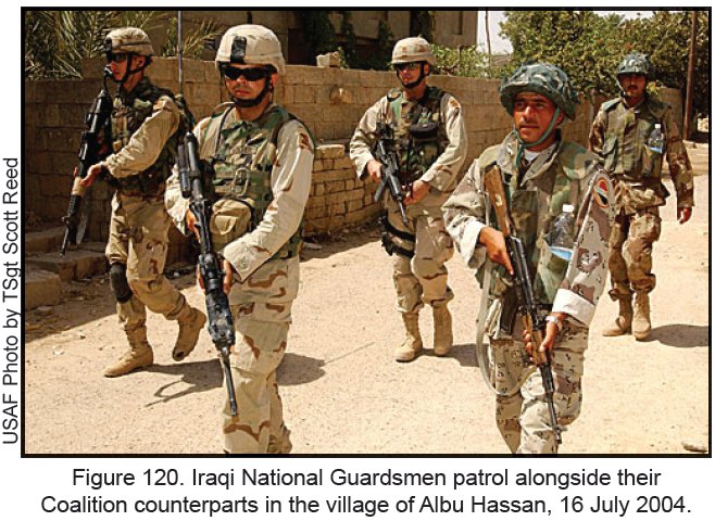Figure 120. Iraqi National Guardsmen patrol alongside their Coalition counterparts in the village of Albu Hassan, 16 July 2004.