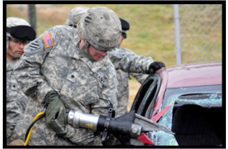 Graphic showing Soldier uses the jaws of life to extract mock-casualties from a damaged vehicle