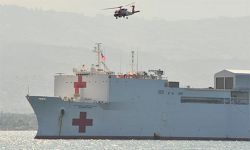 Photo of U.S. Naval hospital ship, USNS Comfort, providing a platform for a U.S. Coast Guard HH-60 Jayhawk helicopter