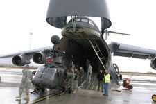 Photo showing unloading an OH-58D Kiowa Warrior helicopter