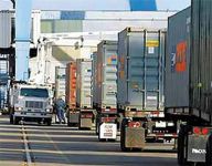 Photo showing line of trucks waiting for inspection