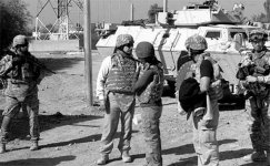Bruce Bailey (white shirt), ePRT deputy chief, and John Smith, ePRT chief, walk the streets of Arab Jabour with security from 2-3d Brigade Troops Battalion Soldiers on 14 November 2007