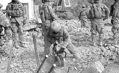 A LEP and soldiers of 3rd Squadron, 2nd Stryker Cavalry Regiment, sift through debris to collect evidence. LEPs are often more patient and attuned to details than the uninitiated soldier, whose mission has traditionally been capturing detainees rather than cataloguing evidence.