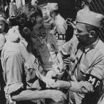Photo showing American military police admitting a father and daughter, both displaced persons, to the refugee shelter