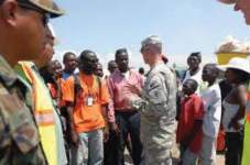 Photo showing MAJ Jon B. Tipton, provost marshal, Joint Task Force Haiti, speaks with residents of Ancien Airport Militaire IDPs