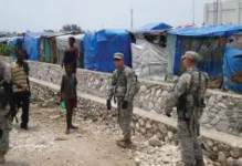 Photo showing U.S. troops assisting at an IDP camp