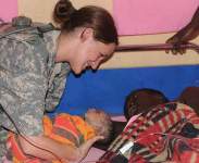 Photo showing Private First Class Kendra Hinds, a U.S. Army Reserve medic, helped deliver a child for a Ugandan woman.