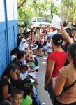 Photo showing people queuing up and waiting