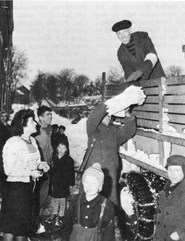 COLLECTING BEDSHEETS DURING BATTLE OF THE BULGE