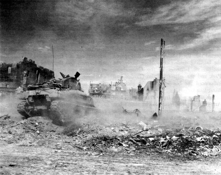 U.S. TANK CRASHES THROUGH RUINS OF A GERMAN TOWN