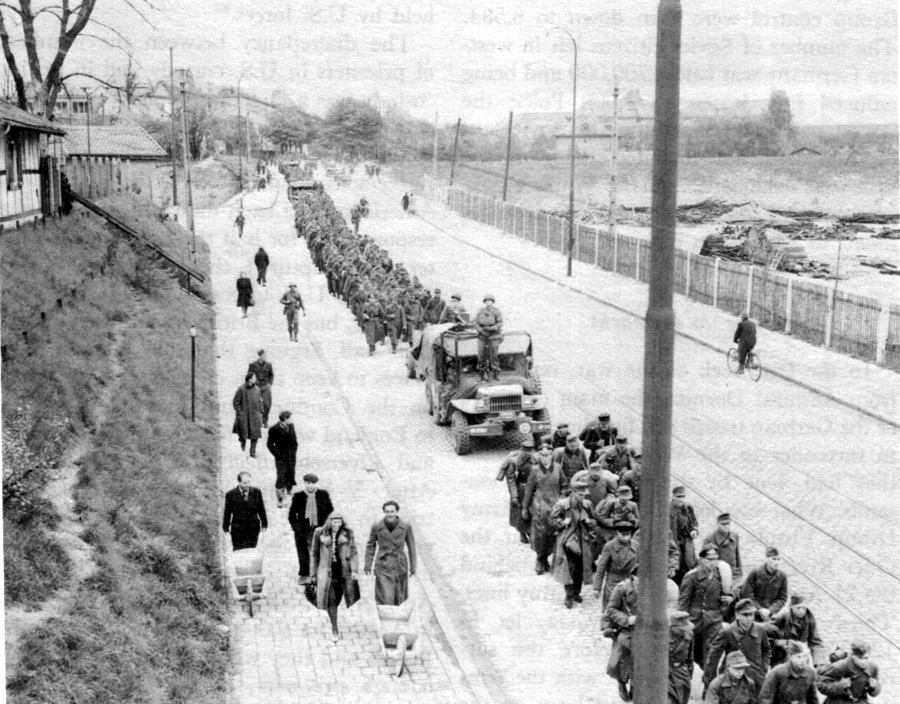 PRISONER OF WAR COLUMN marches through Munich.