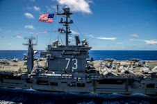 USS George Washington (CVN-73) flies the U.S. Navy battle ensign and the 297-foot Homeward Bound Pennant on July 27, 2015.