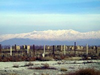 View of mountains fomr Bagram Airfield. The metal posts and wire indicate a protective minefield emplaced during the Northern Alliance's defense of the airfield