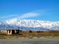 View of the Kohe-Safi Mountains from Bagram Airfield. Earthen mounds in the foreground are protective berms surrounding former aircraft parking slots from the Soviet occupation