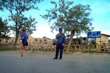 A coalition soldier jogs past an Afghan worker at Bagram Air Base in Afghanistan