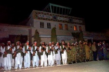 Mujahedin soldiers stand in formation at an airstrip terminal in Herat, Afghanistan, during a visit by U.S. Defense Secretary Donald H. Rumsfeld in April 2002
